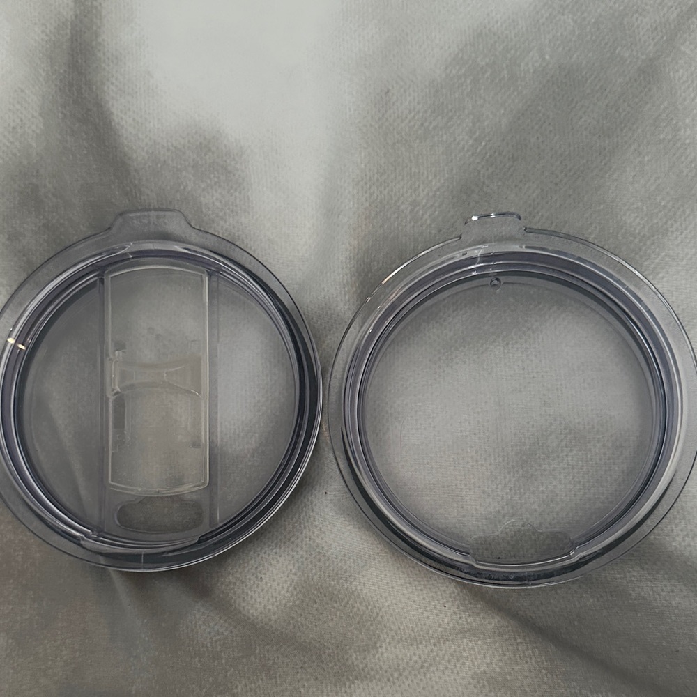 RTIC Clear Plastic Tumbler Lids. One has a non magnetic slider.